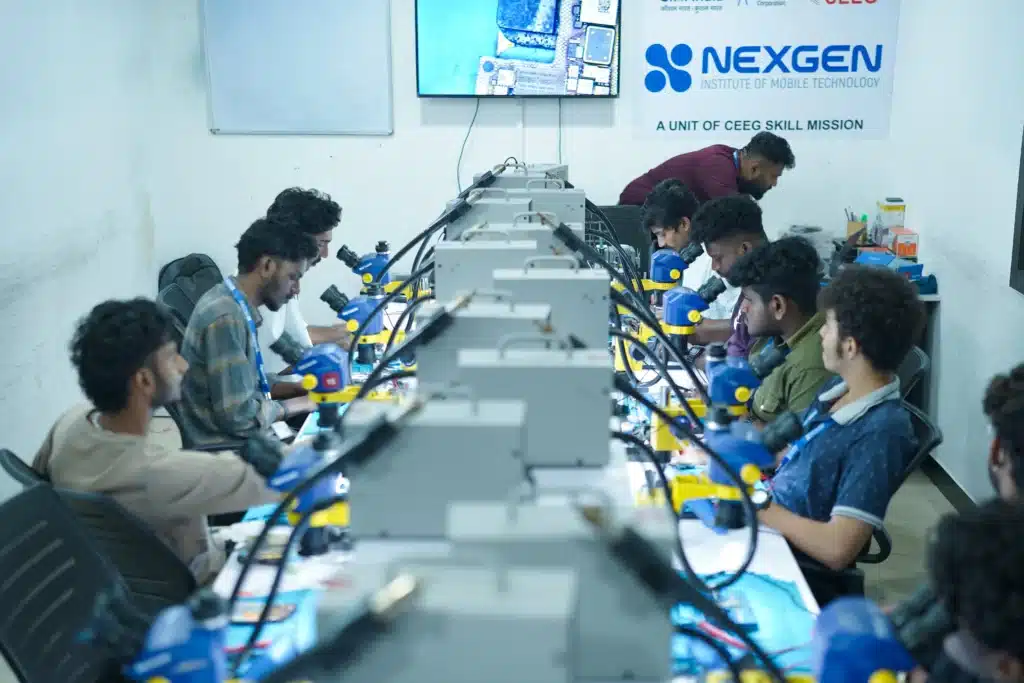 iPhone repair training students working on real devices at Nexgen Institute's professional repair lab in Kochi, Kerala